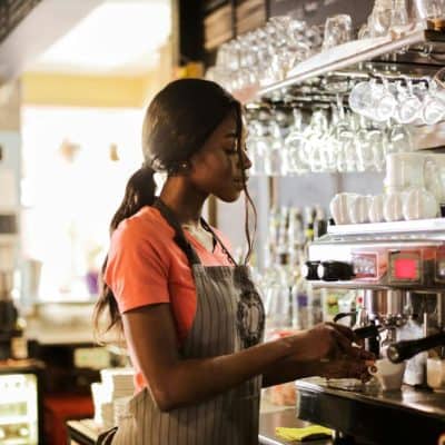girl making coffee in a coffee shop
