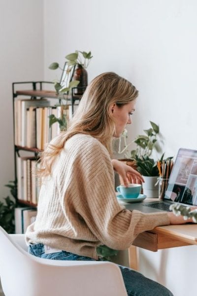 woman seated at desk looking at computer