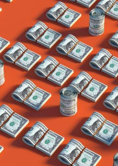 image of orange background with rolls of cash on it