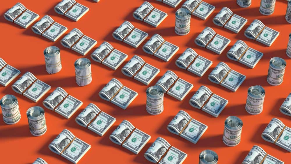 image of orange background with rolls of cash on it