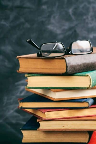 stack of books with glasses on top