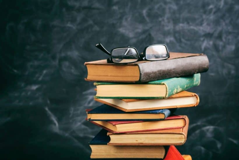 stack of books with glasses on top