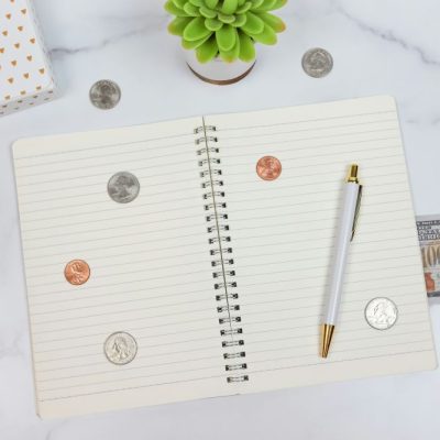 notebook with pen, coins and cash