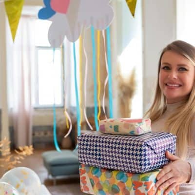 woman holding several wrapped gifts