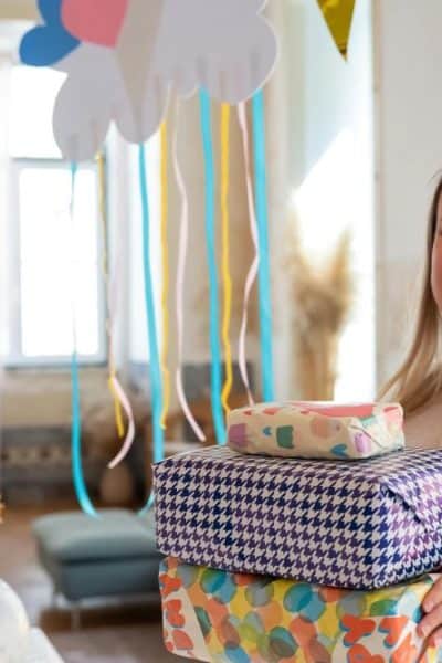 woman holding several wrapped gifts