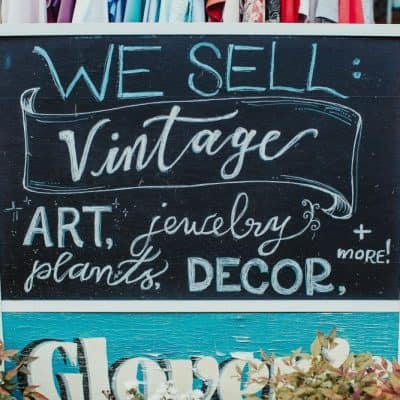 sign featuring text reading "we sell vintage, art, jewelry, plants decor and more"