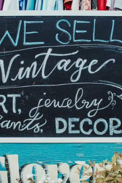 sign featuring text reading "we sell vintage, art, jewelry, plants decor and more"