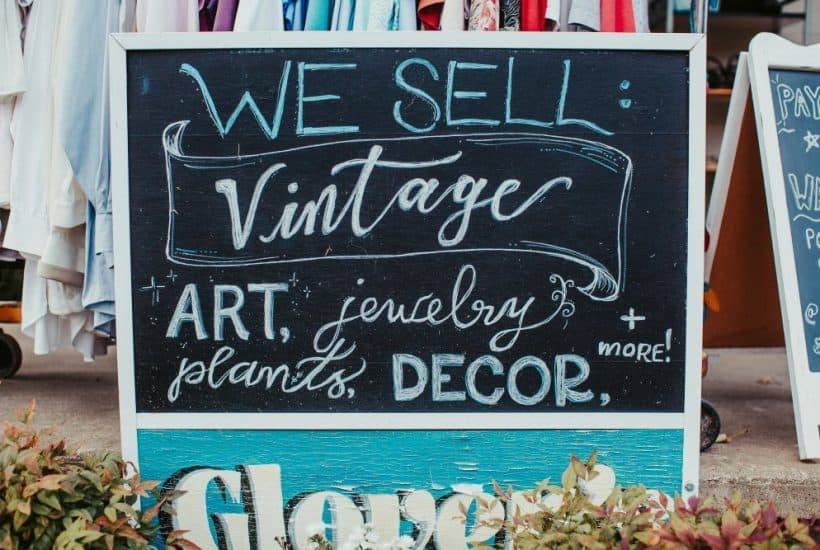 sign featuring text reading "we sell vintage, art, jewelry, plants decor and more"