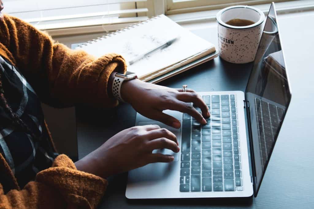 freelancing computer person using black and silver laptop computer