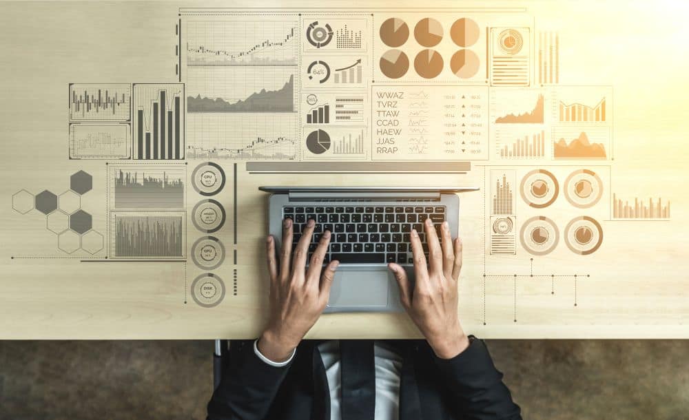 overhead view of hands on a laptop with graphics around